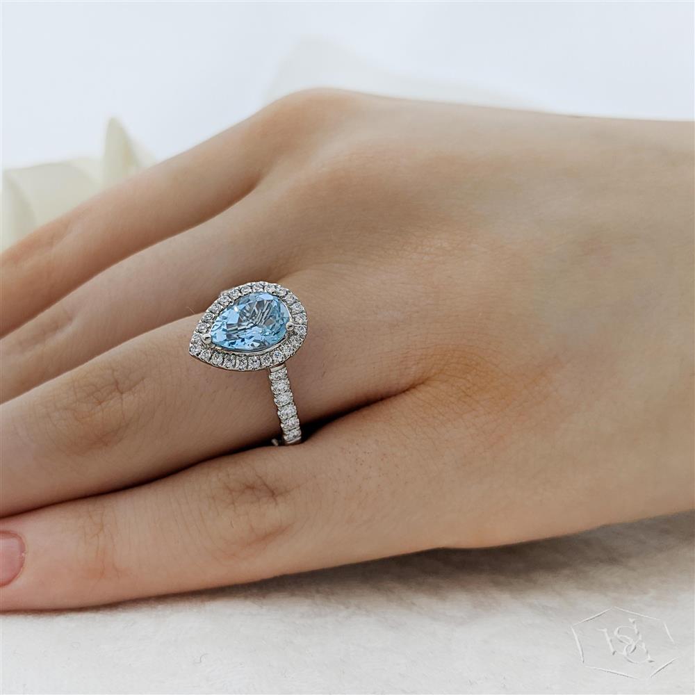 pear shape cut aquamarine in a platinum cluster diamond band