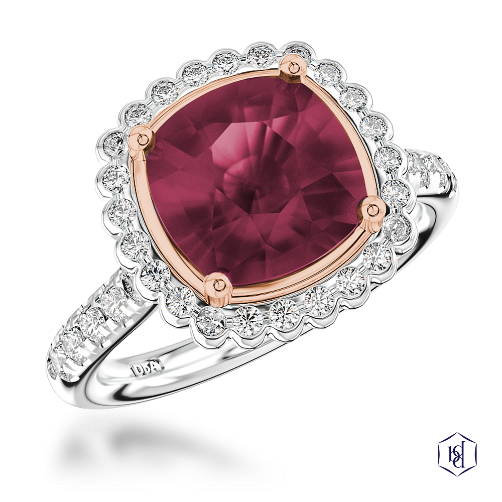 cushion cut ruby in a platinum shank and 18ct rose gold head cluster diamond band