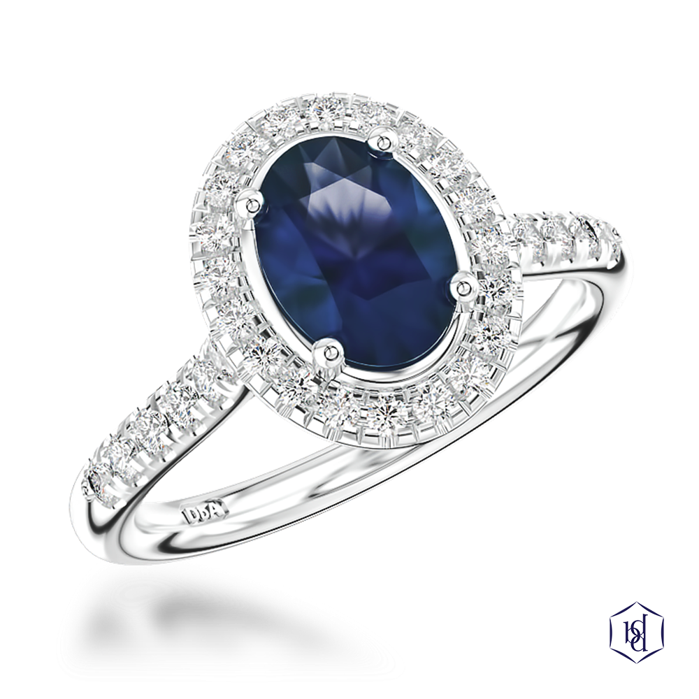 oval cut sapphire in a platinum cluster diamond band