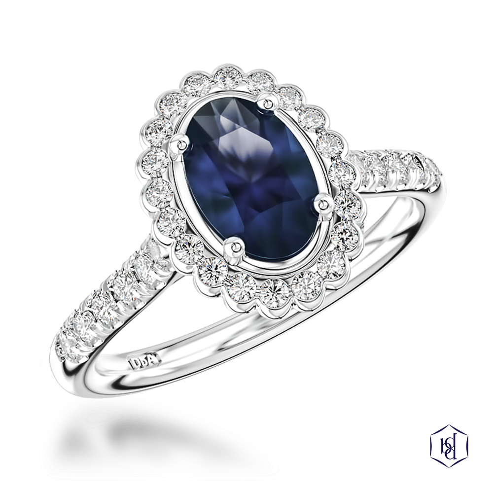 oval cut sapphire in a platinum cluster diamond band