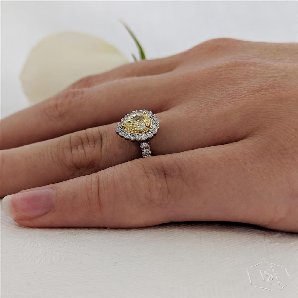 pear shape cut yellow diamond in a platinum shank and18ct yellow gold head cluster diamond band