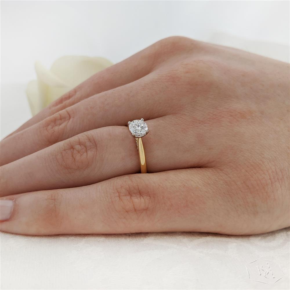 round brilliant cut diamond in a 18ct yellow gold shank and platinum head solitaire plain band